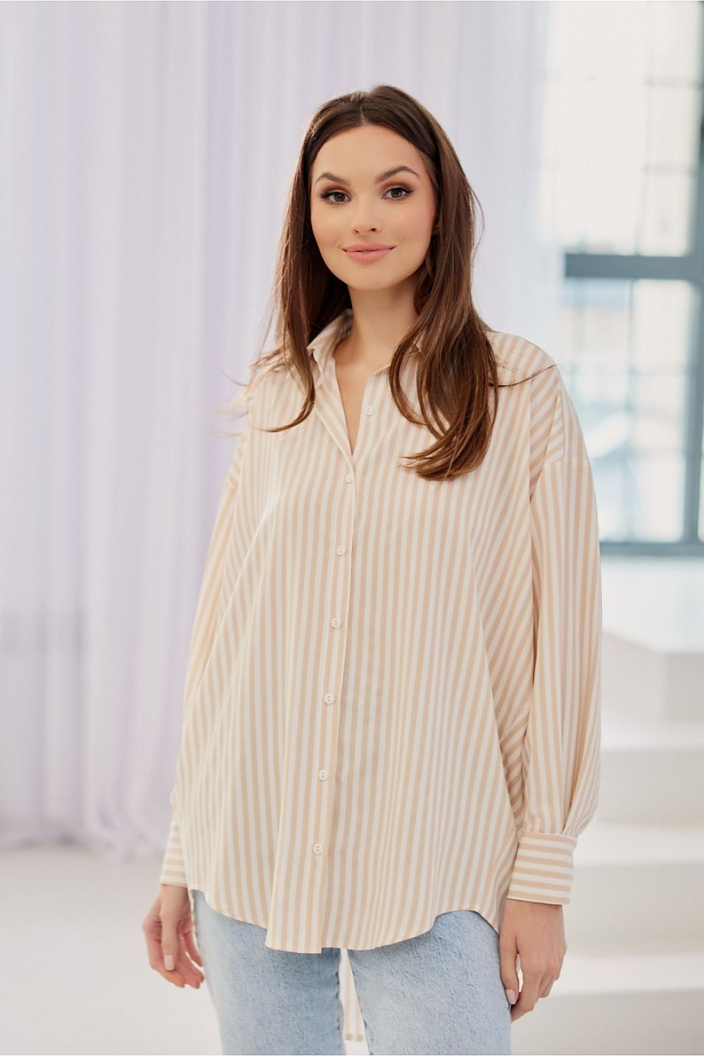 Women's striped shirt is distinguished by its oversize cut with Long sleeves