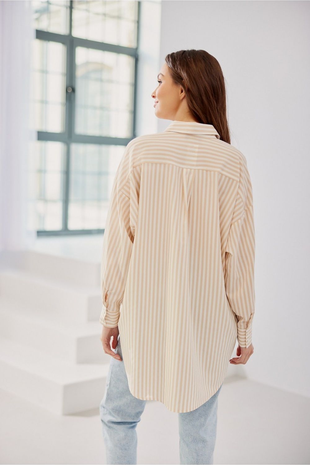 Women's striped shirt is distinguished by its oversize cut with Long sleeves