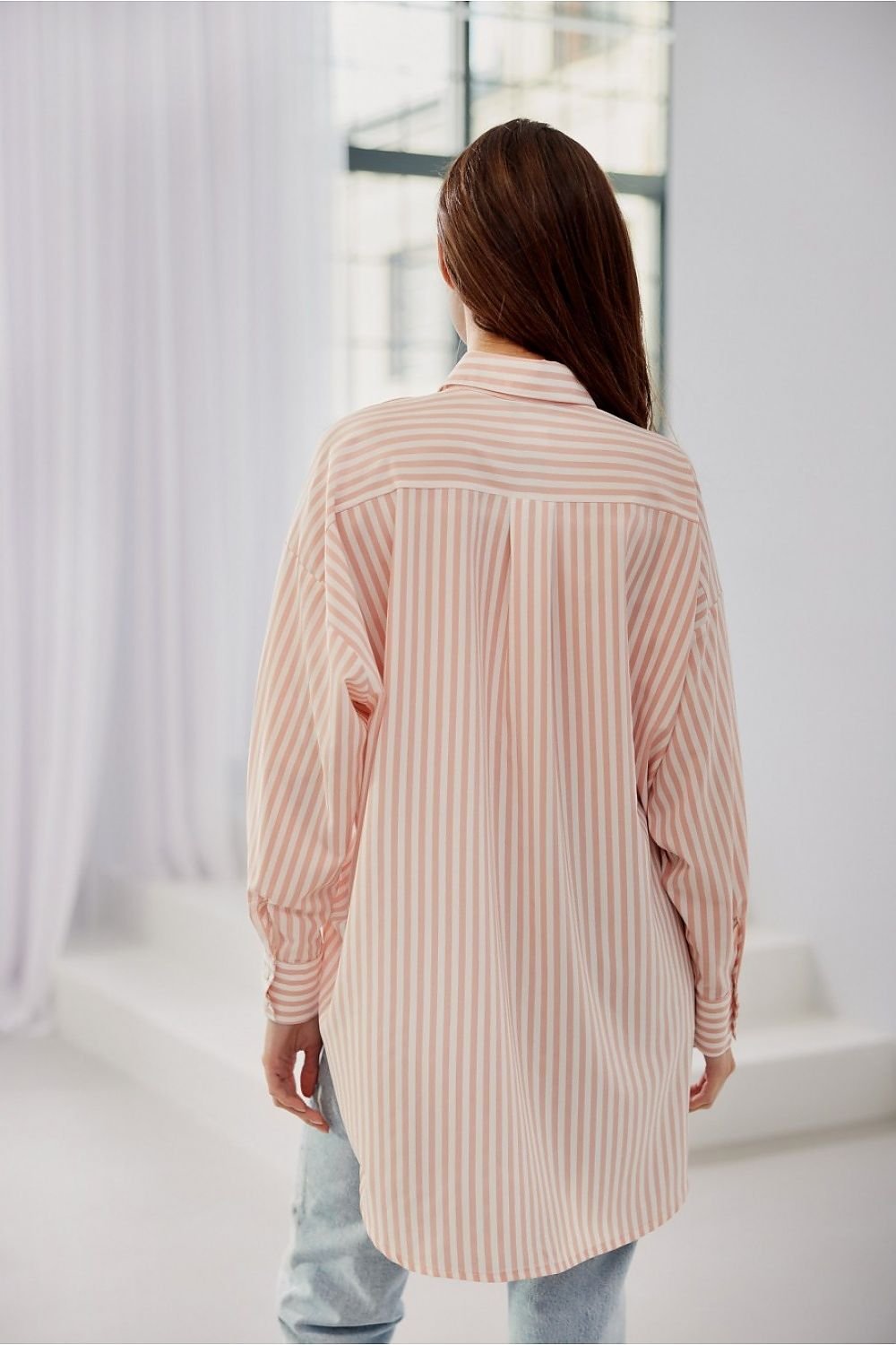 Women's striped shirt is distinguished by its oversize cut with Long sleeves