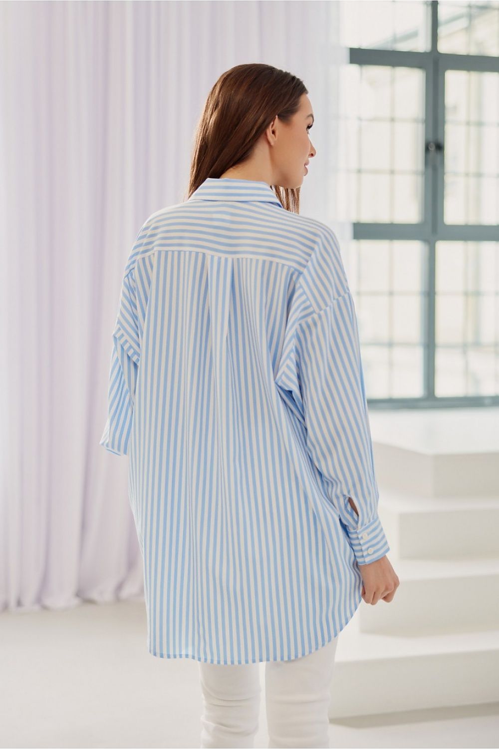 Women's striped shirt is distinguished by its oversize cut with Long sleeves