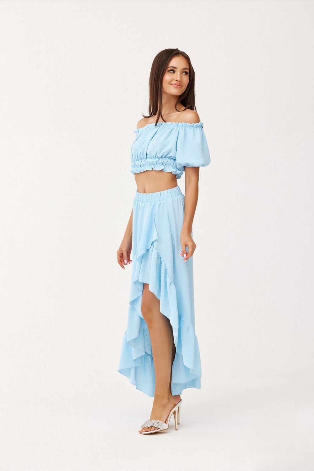 The asymmetrical blouse and skirt set is made of soft, pleasant fabric